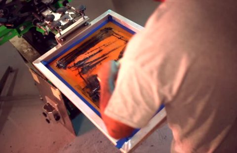 A master screen printer works in his workshop, preparing screen printing inks and molds.